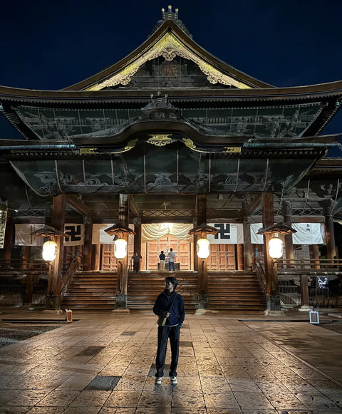 traveller outside zenko-ji temple, nagano in night on a beyond tokyo journey