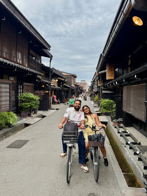 couple on cycle in sanmachi suji, takayama on a beyond tokyo journey